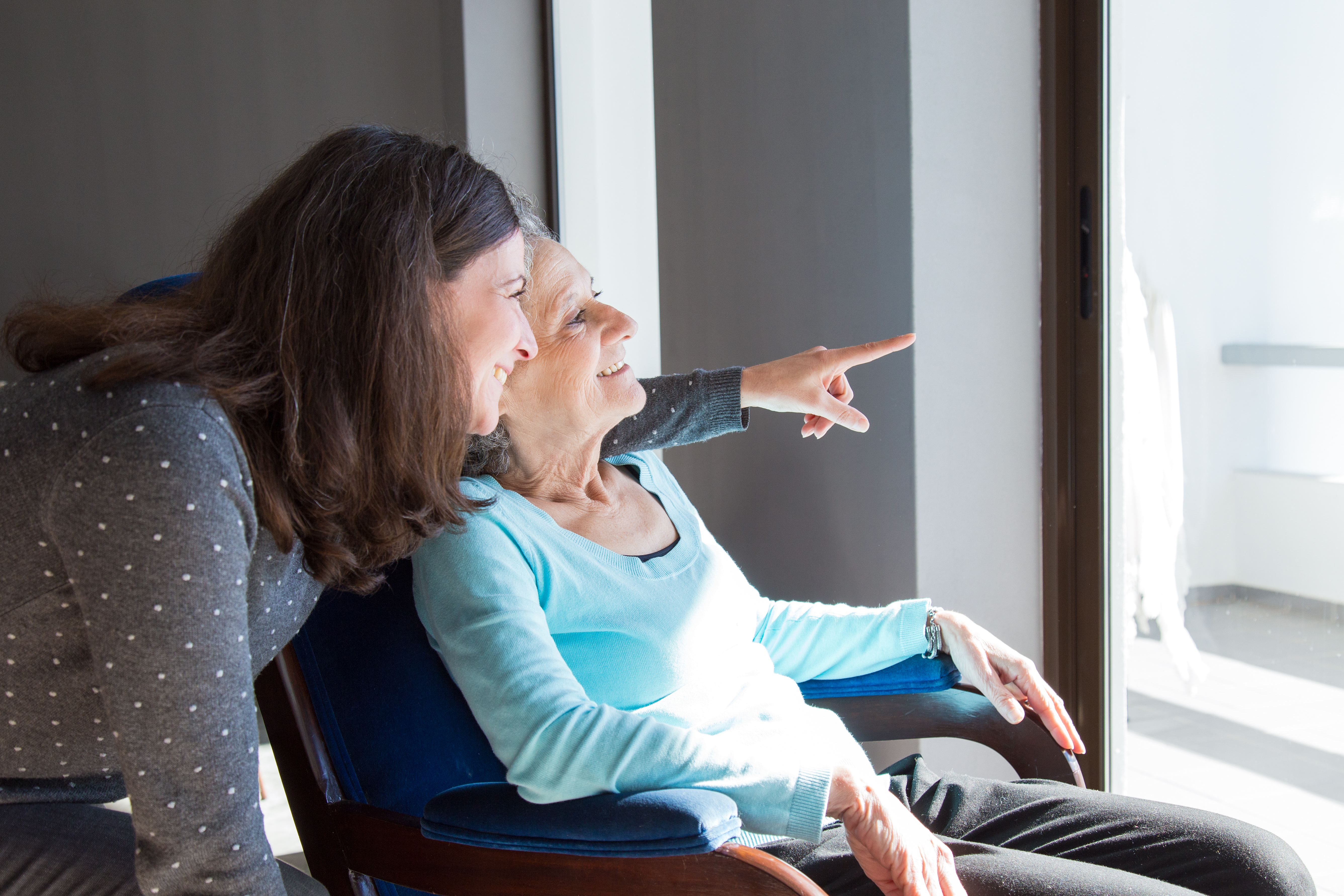 side view of a female carer an elder man a high-five